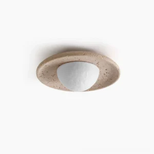 Jenny natural travertine flush mount ceiling light overhead view showing textured stone rim and frosted dome diffuser in minimalist studio setting