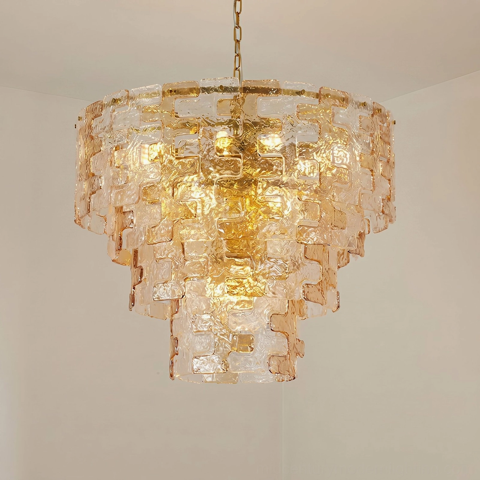 Jigsaw tiered glass chandelier detail shot showing water-ripple texture and geometric pyramid construction