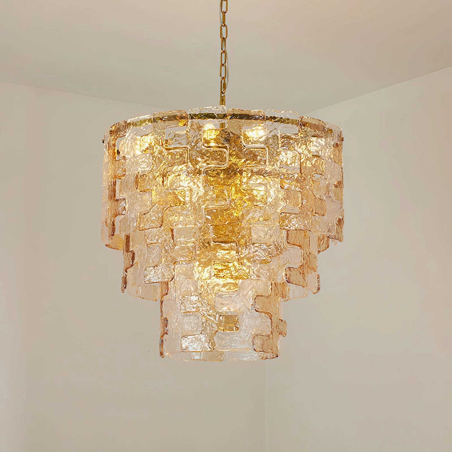 Jigsaw tiered glass chandelier in clear and amber glass finish options showing style versatility