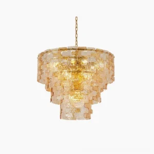 Jigsaw tiered amber glass chandelier with inverted pyramid silhouette on white studio backdrop