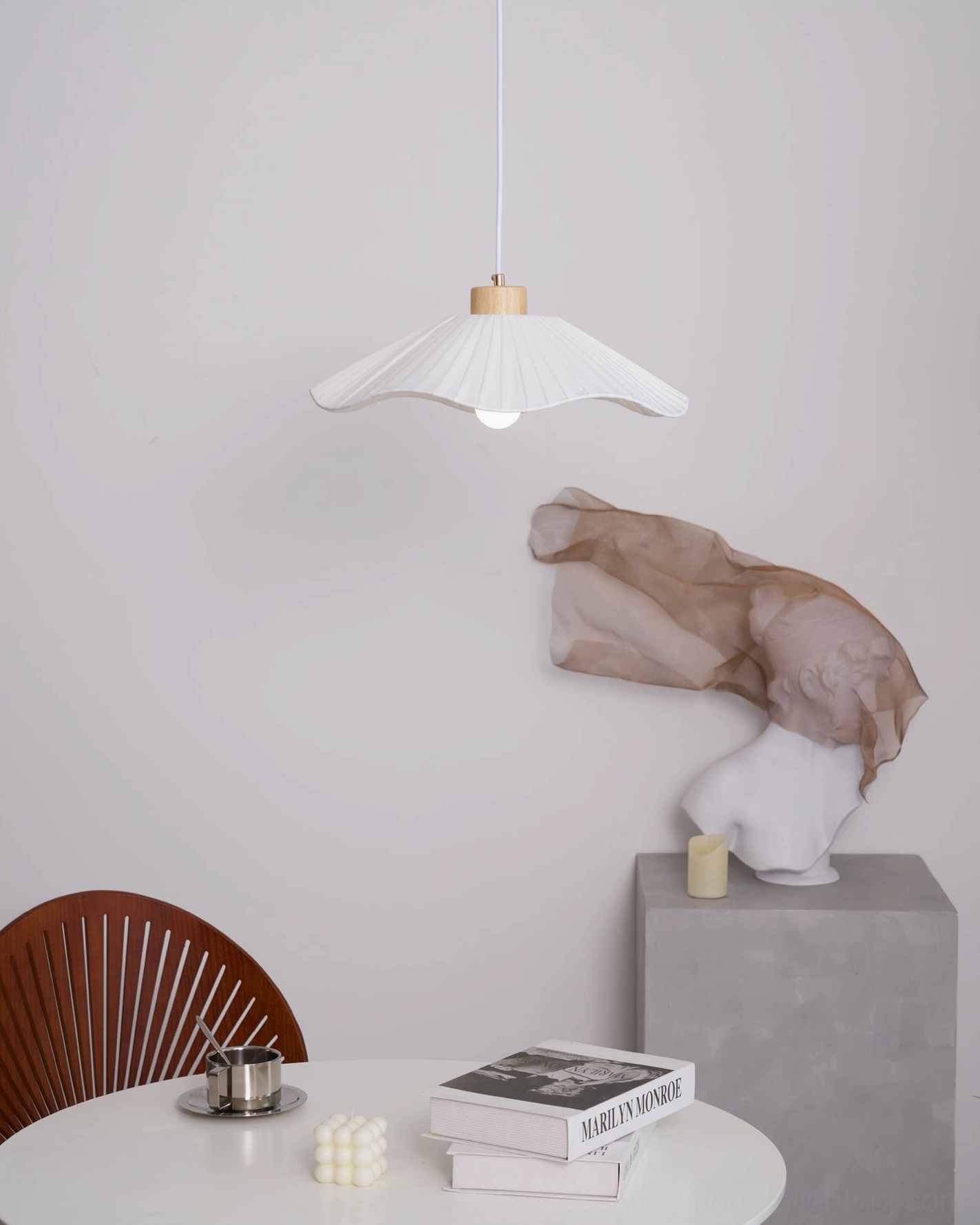 Jimi pleated pendant light paired with neutral tone table decor and abstract sculpture, Scandinavian interior styling