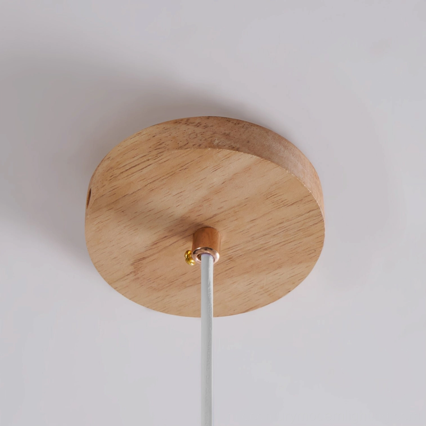 Jimi pendant light in contemporary living space, sculptural pleated shade with wood accents, warm glowing ambiance