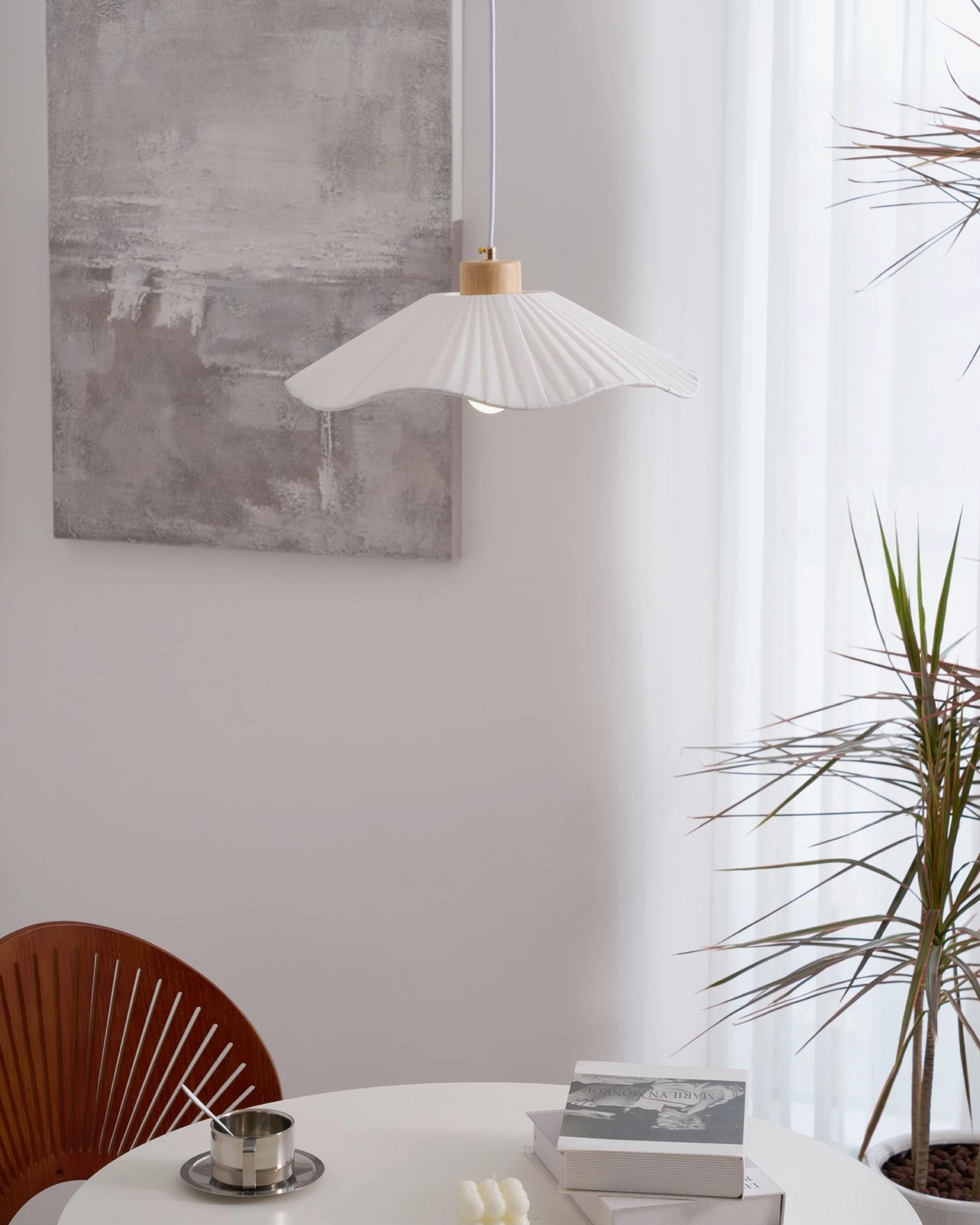 Jimi fabric pendant light installation view, white pleated shade creating soft glowing ambiance in minimalist modern home