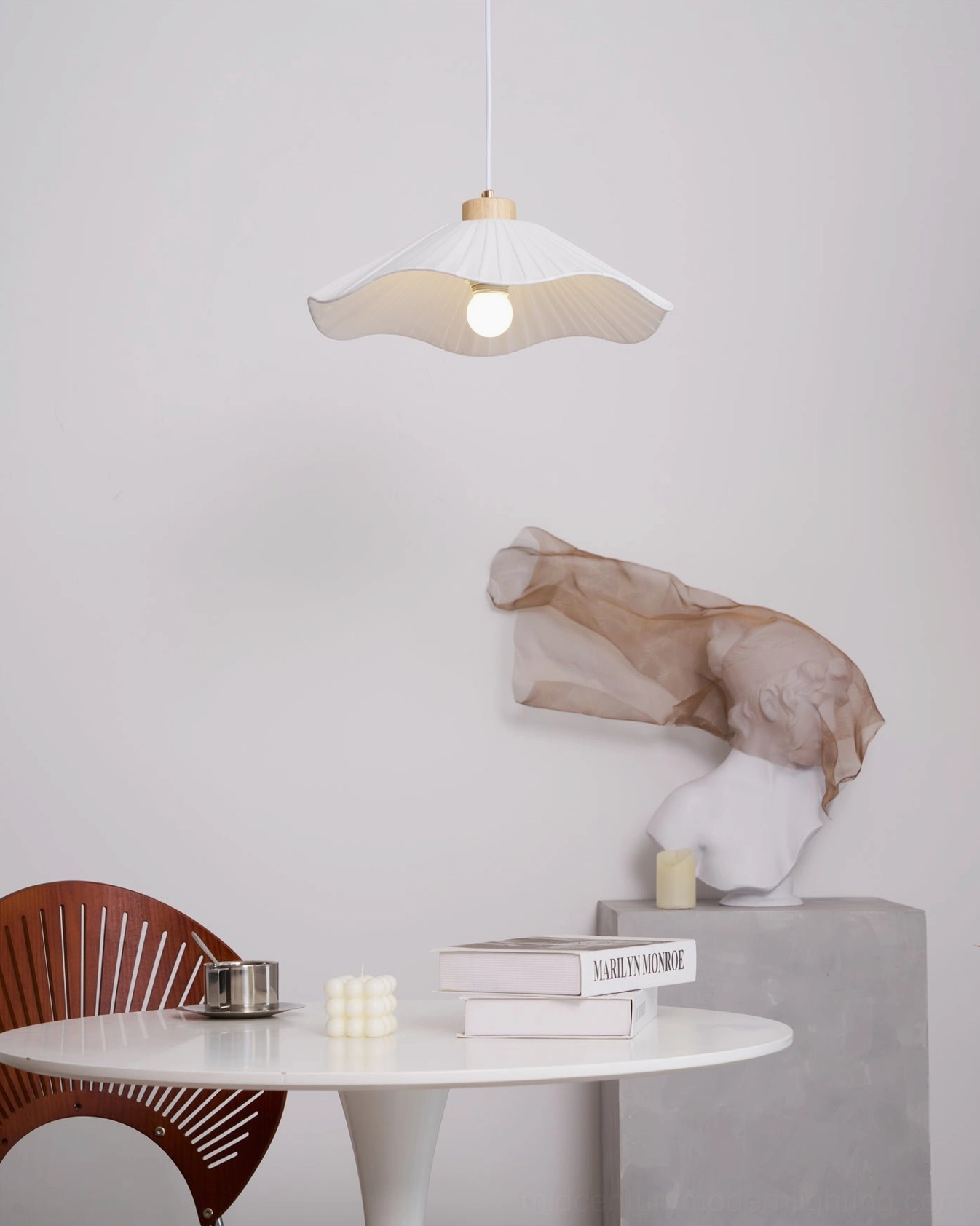Jimi pendant light showing pleated textile detail, wooden collar mount, diffused warm light in contemporary home setting