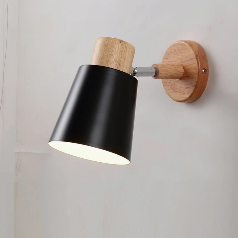 Joan mid-century modern wall lamp black finish, front close-up showing conical shade geometry and wood base construction
