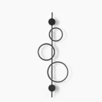 Jocco vertical ring wall lamp studio shot - modern minimalist matte black metal design with hollow circular form