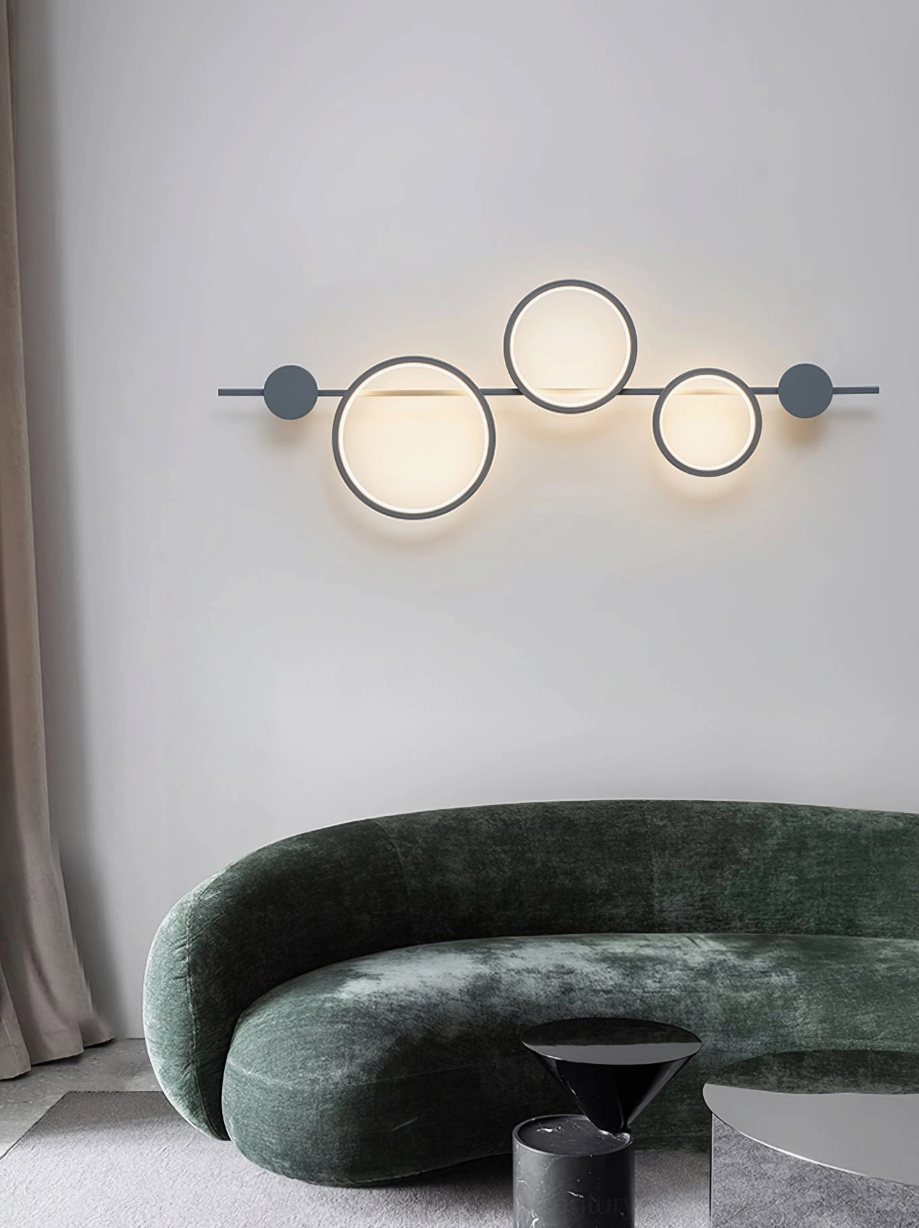 Modern living room with Jocco horizontal ring wall lamp above velvet sofa minimalist warm lighting