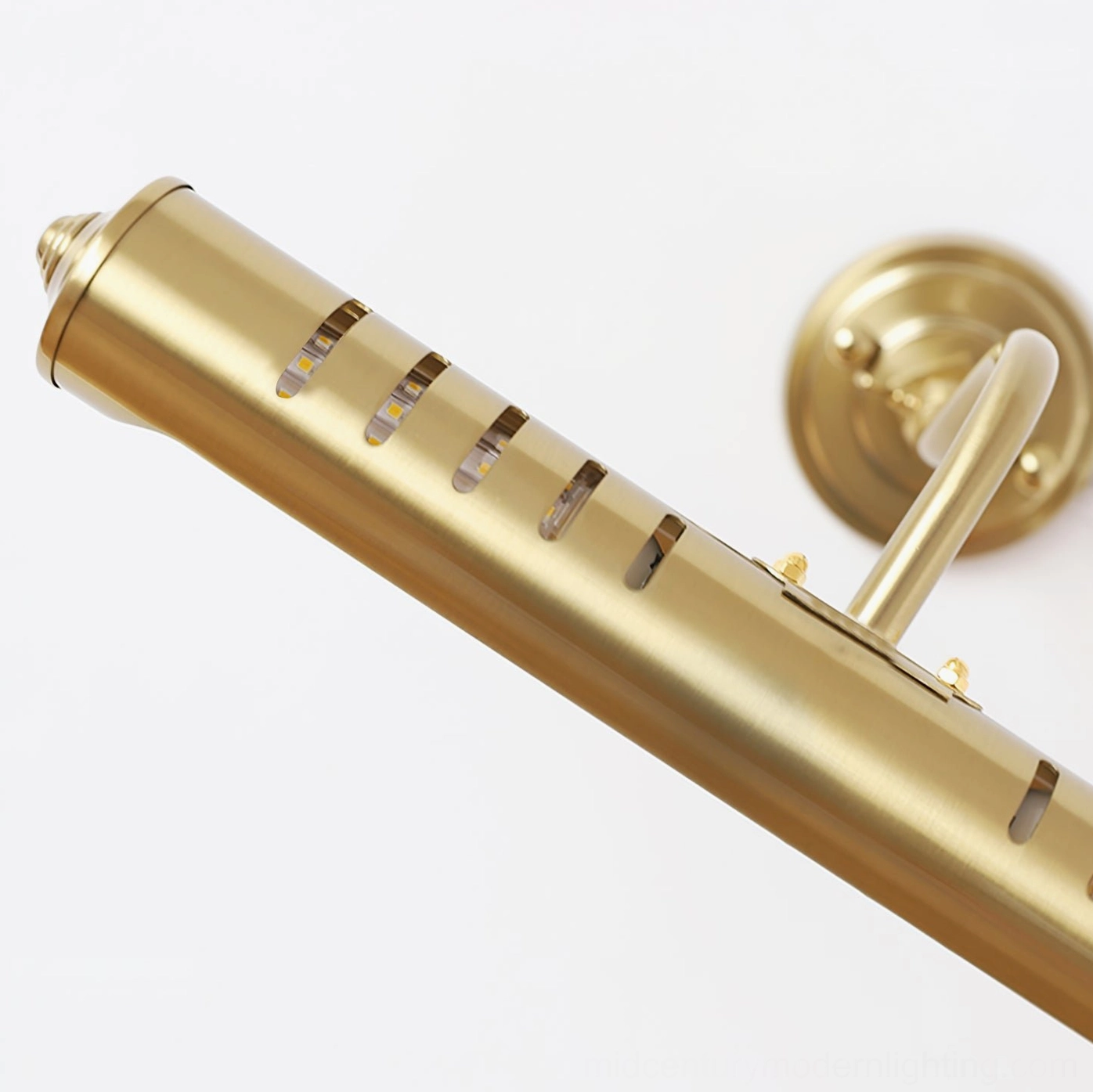 Joely brass wall lamp close-up detail showing slotted ventilation holes and metal finish craftsmanship