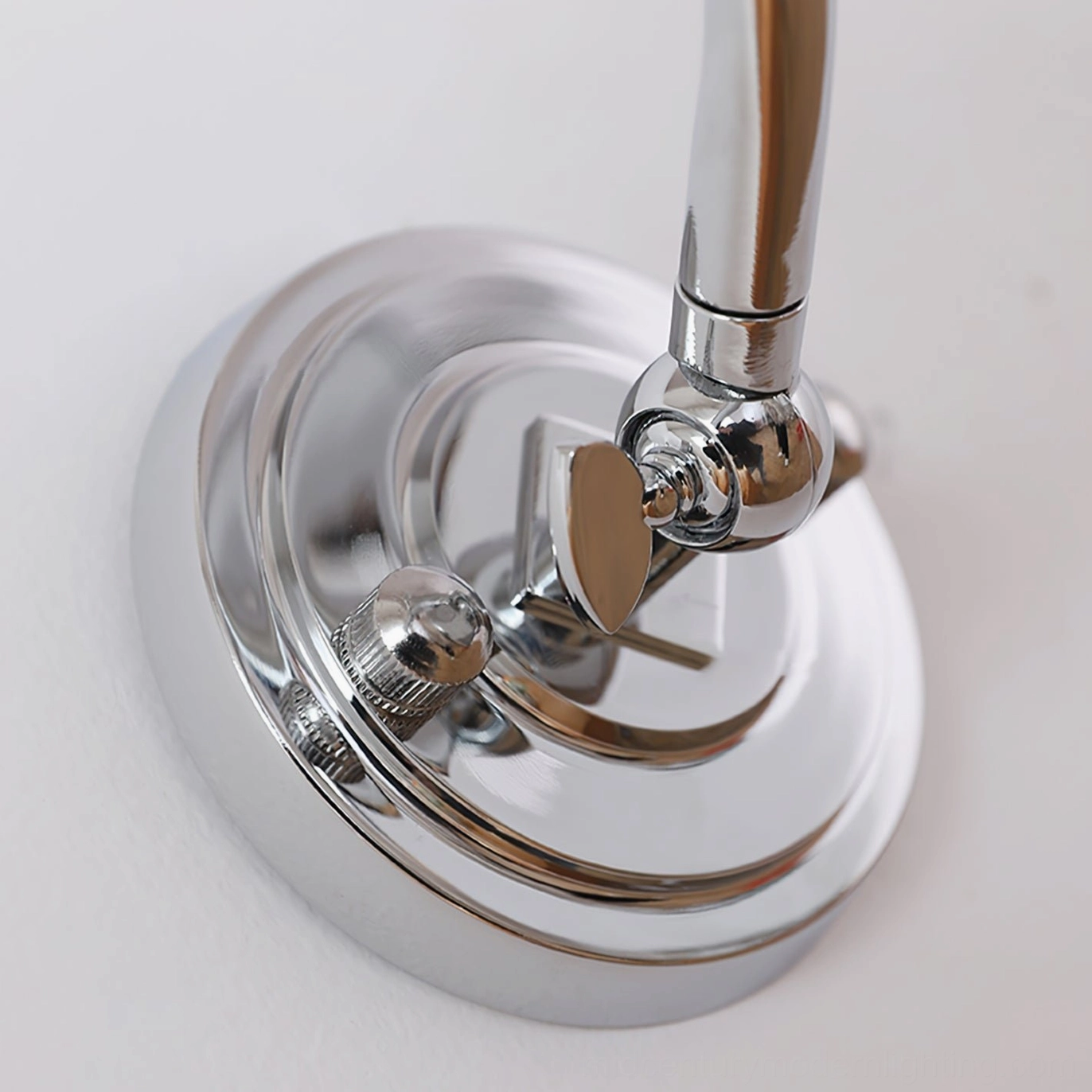 Joely chrome wall light fixture top-down close-up revealing adjustable joint and polished surface