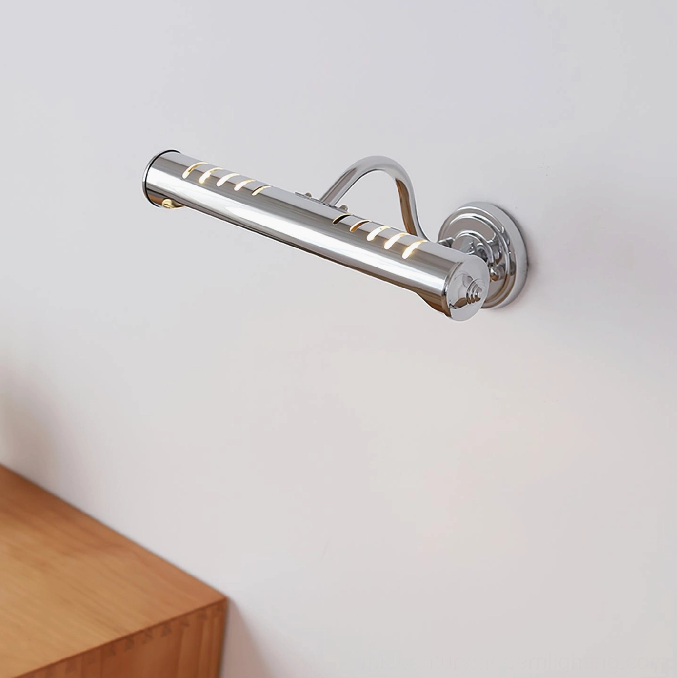 Joely chrome wall light fixture mounted beside wooden furniture showing interior styling application