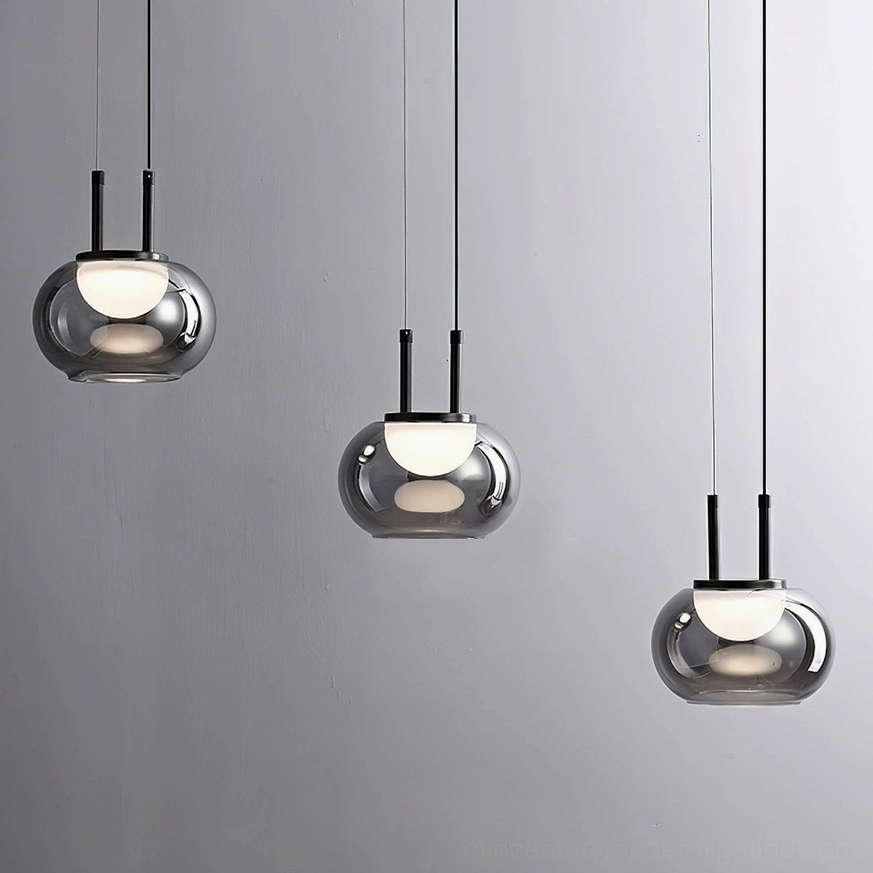 Three-head Johan pendant lights evenly arranged on white studio background