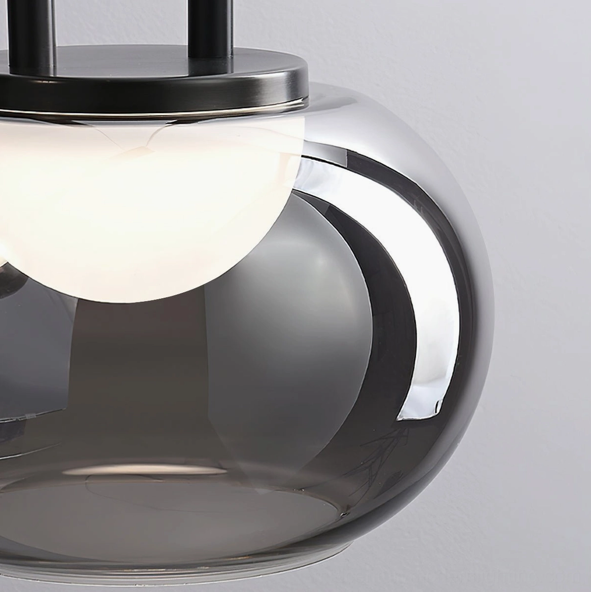 Extreme close-up of Johan pendant showing glass texture and black metal hardware