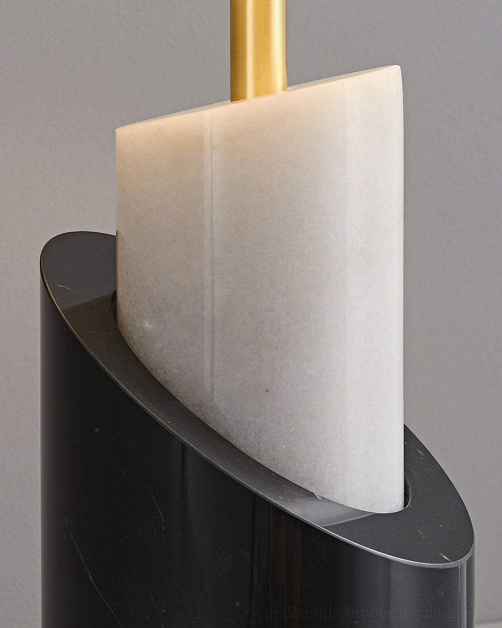 Close-up of Jude lamp base showing black marble, white stone insert, and brass stem detail
