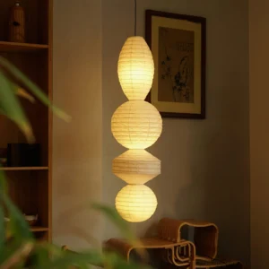 Juni paper pendant lamp illuminated in tea room wooden shelf warm ambient glow