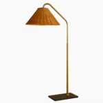 Juno arched rattan floor lamp with brass gold metal frame and hand-woven natural rattan cone shade, direct front view product photography