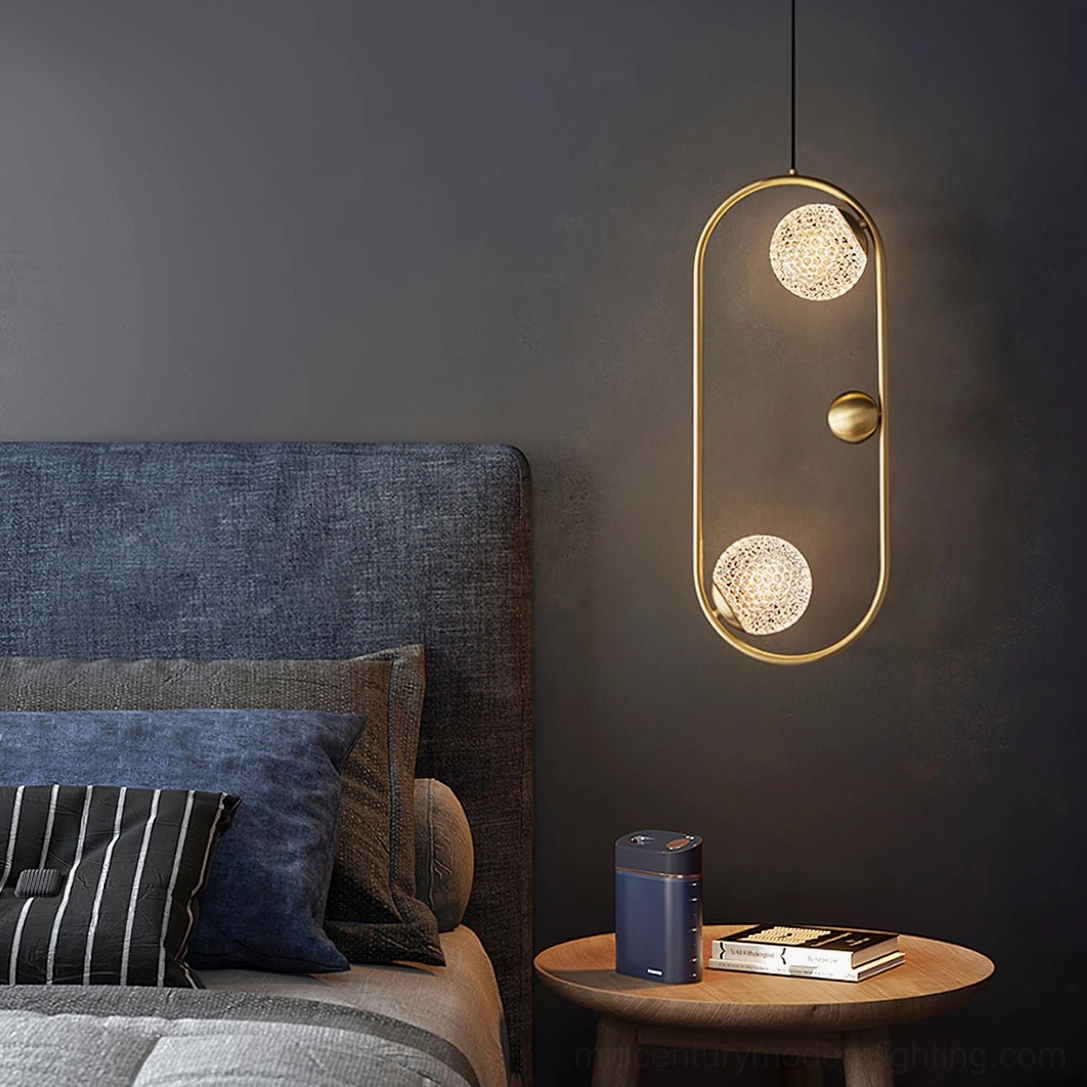 Single Jupiter brass pendant lamp hanging in master bedroom with dark accent wall, creating sophisticated upscale bedroom ambiance