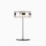 Kaede minimalist table lamp with polished chrome stem and clear acrylic shade, front studio view