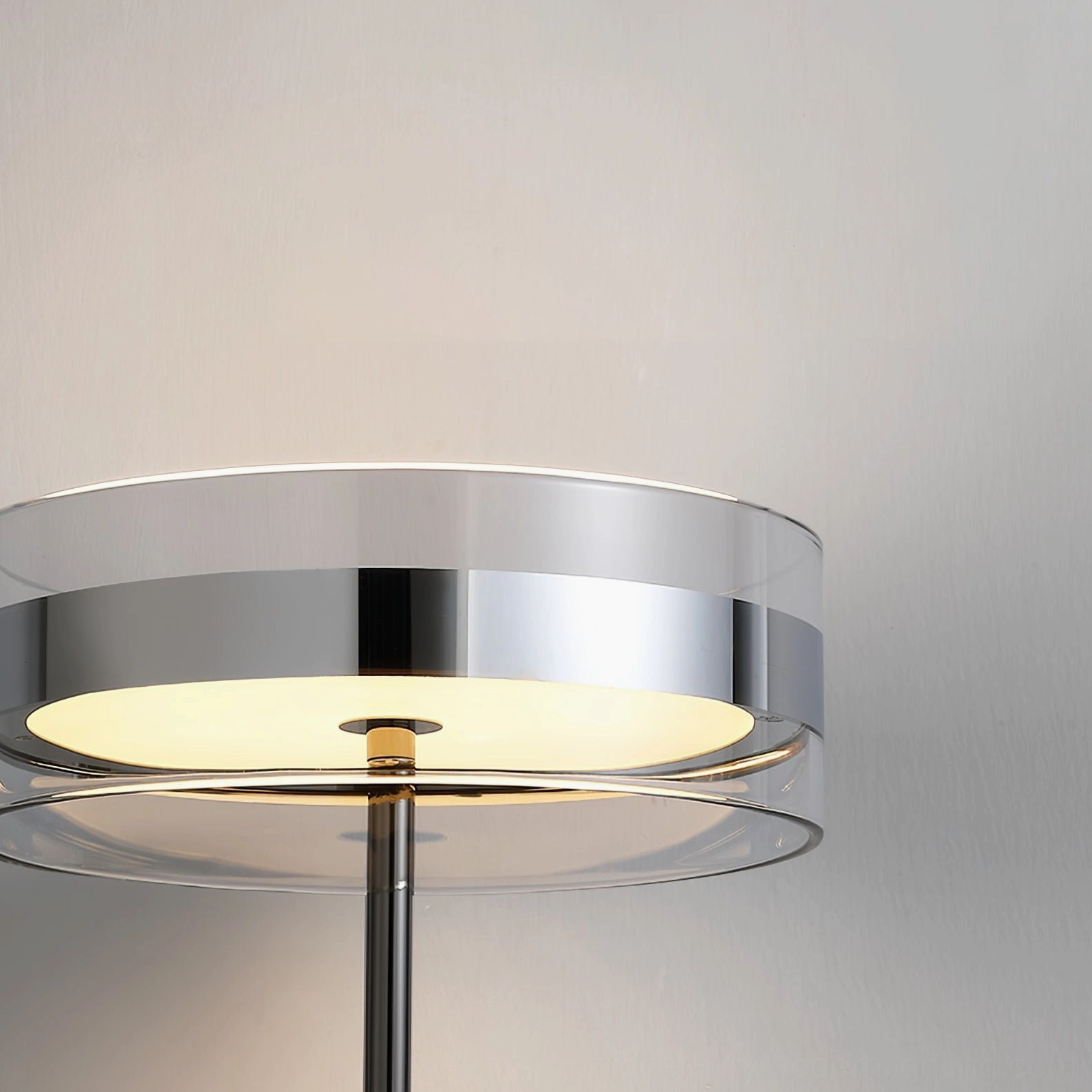 Kaede torchiere lampshade close-up detail with double-layer clear glass dome and chrome trim diffusing warm LED light