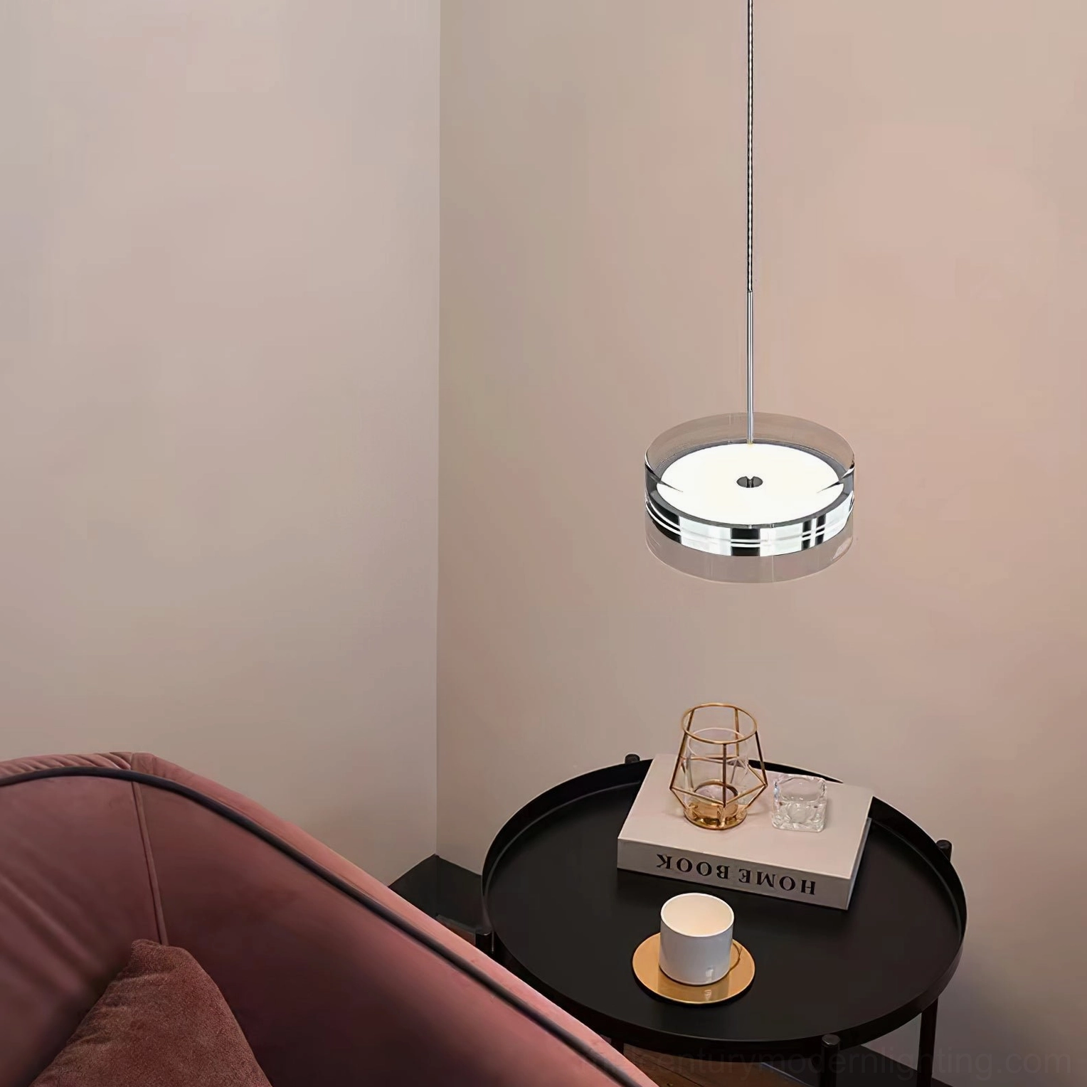 Single Kaede pendant light in modern lounge corner with pink velvet sofa, warm minimalist ambiance