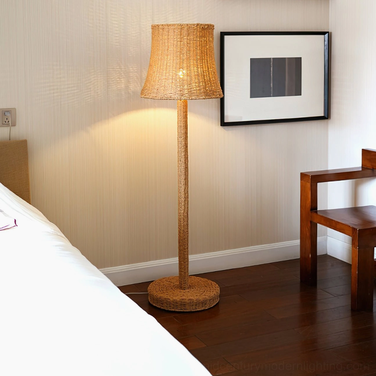 Kakasi rattan floor lamp beside bed with framed wall art, bedroom lighting design for mid-century modern bedroom