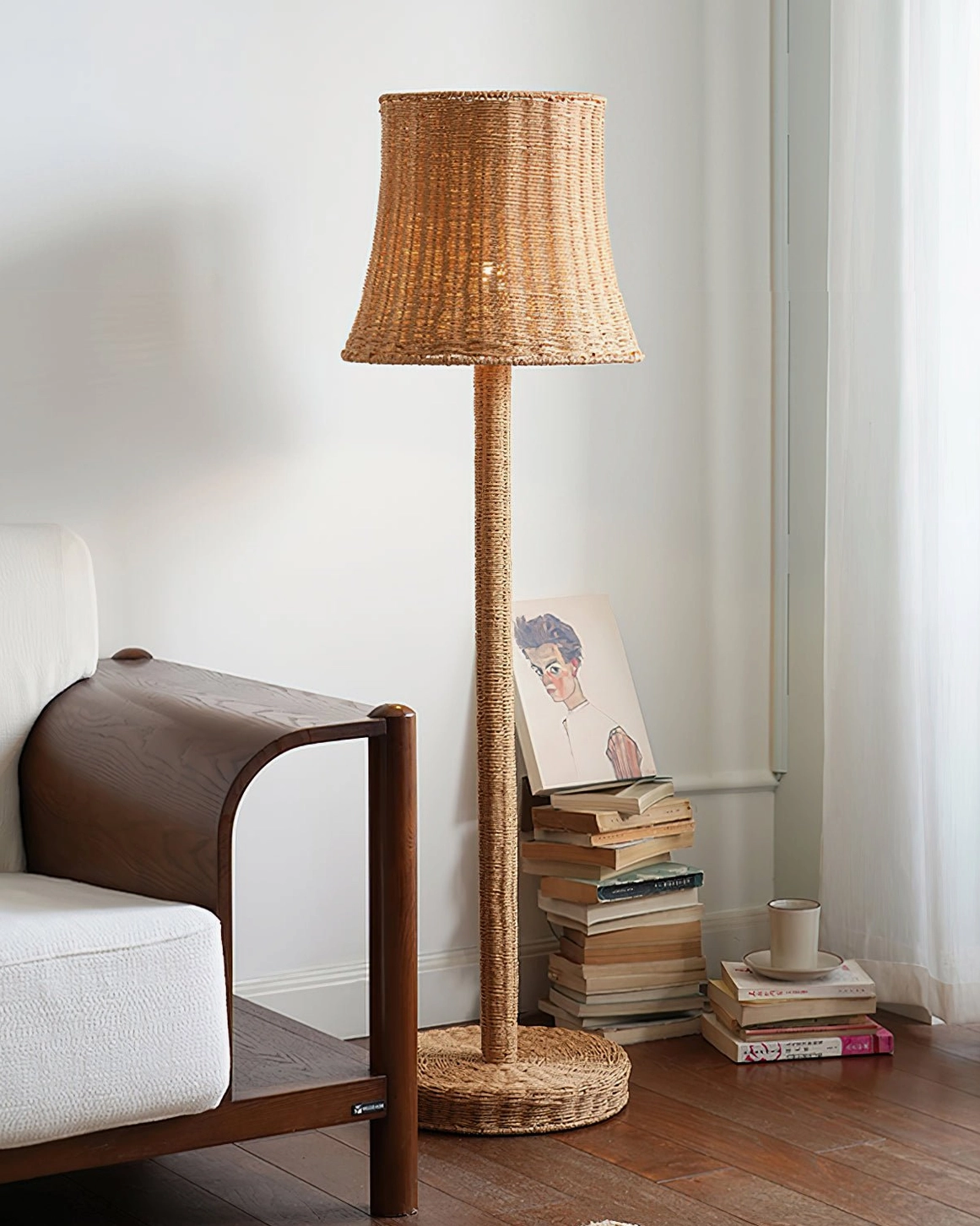 Kakasi rattan floor lamp beside side table with magazines in sunlit living room, ambient mood lighting