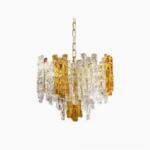 Kalmar mid-century modern layered glass pendant light featuring clear and amber textured glass panels with brass frame on white studio background