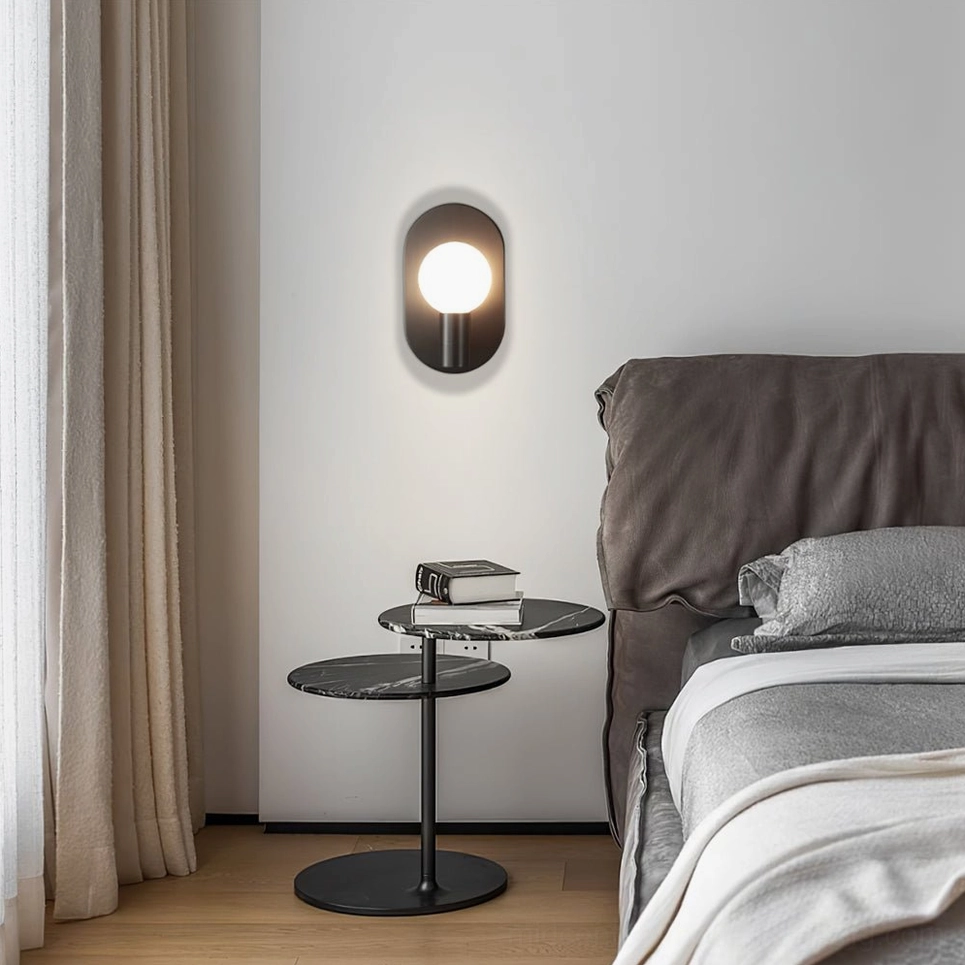 Kalux black wall lamp illuminating modern bedroom with bed and side table warm glow aesthetic