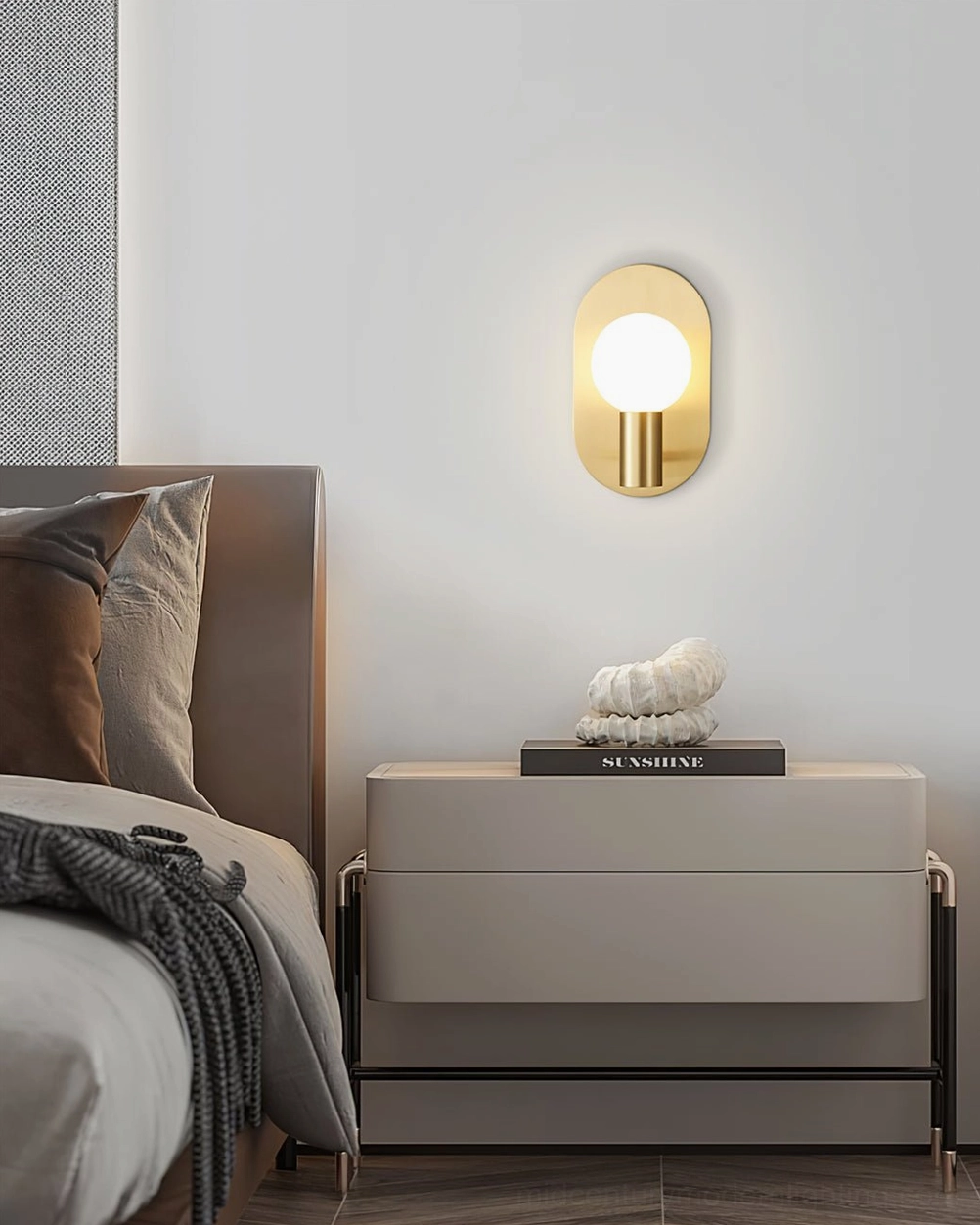 Kalux brass gold wall sconce with polished finish and frosted glass globe in bedroom setting