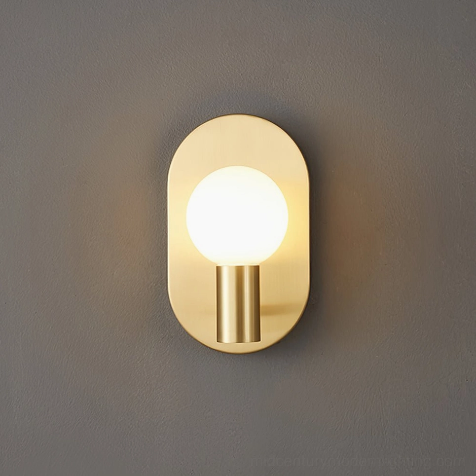 Kalux brass wall lamp with warm gold patina and frosted glass accent for mid-century interiors