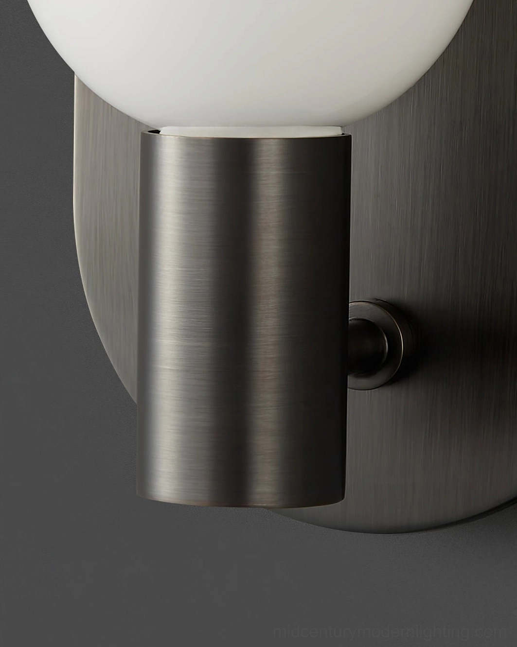 Kalux black metal wall sconce with frosted glass showing minimalist aesthetic from front angle