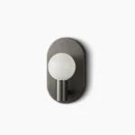 Kalux mid-century modern wall sconce with matte black metal base and frosted glass sphere front view
