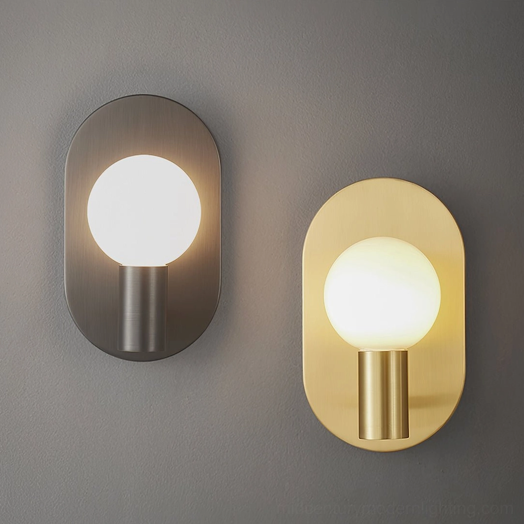 Two Kalux wall sconces side by side comparing black matte and brass gold finishes on gray wall