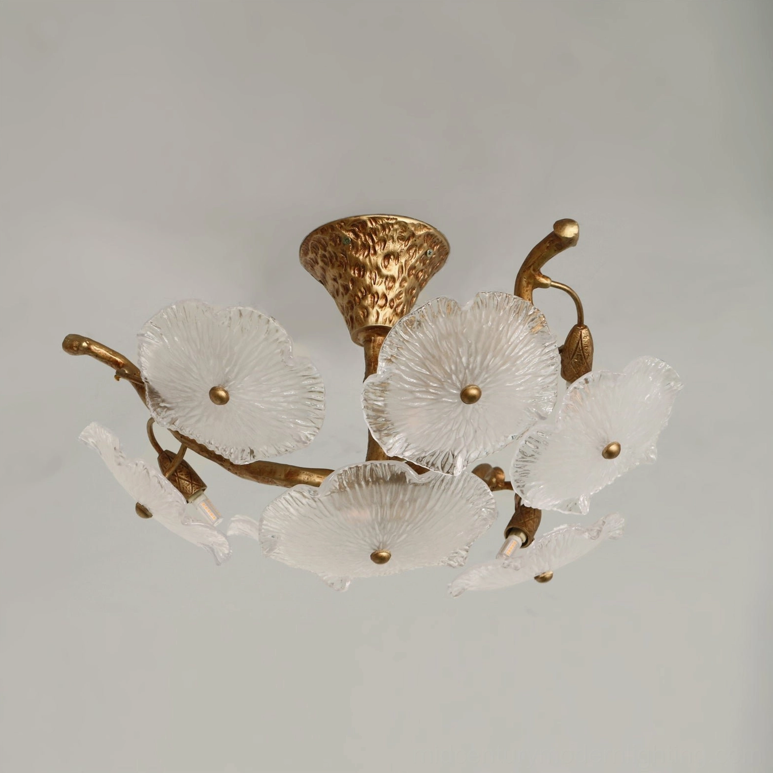 Contemporary Kamal flush mount ceiling lamp with antiqued brass and clear textured glass