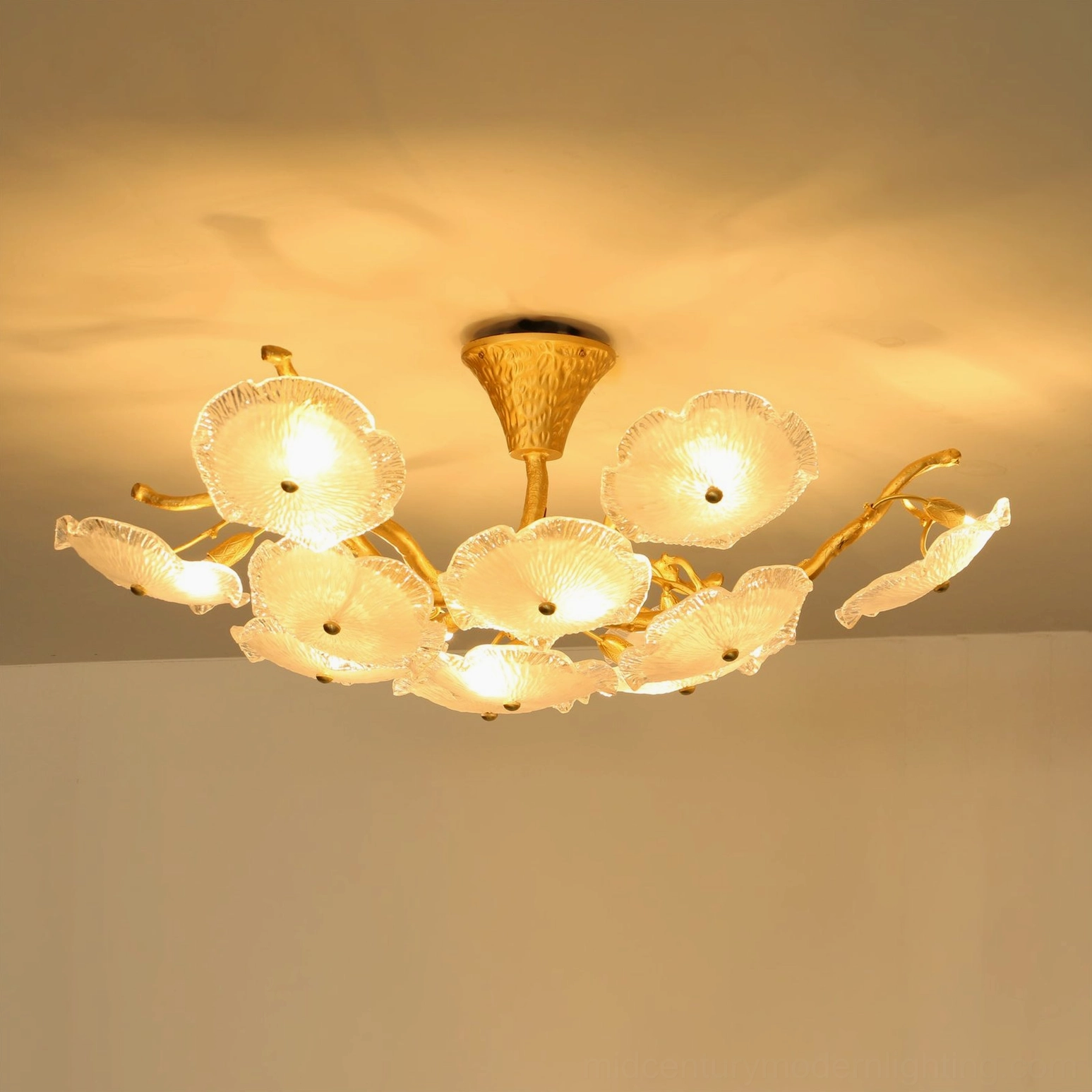 Luxury illuminated Kamal ceiling fixture with curved brass arms and ambient warm light, home ceiling installation
