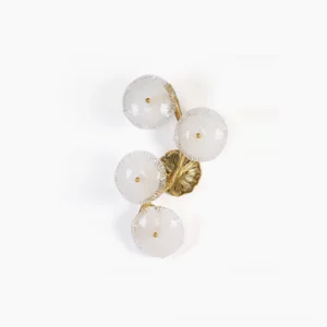 Kamal brass wall sconce with lotus glass shades, overhead studio view showing sculptural branch frame and ribbed glass details