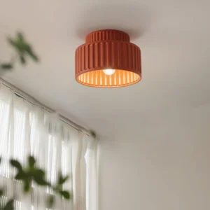 Kami flush mount ceiling light installed in minimalist living room with sheer curtains and green plants, warm ambient lighting