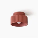 Kami ribbed resin ceiling lamp with terracotta matte finish, front view showing two-tier fluted design and exposed E27 bulb