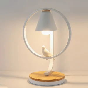 Kamilah mid-century modern table lamp with warm Edison bulb illuminated on home office desk