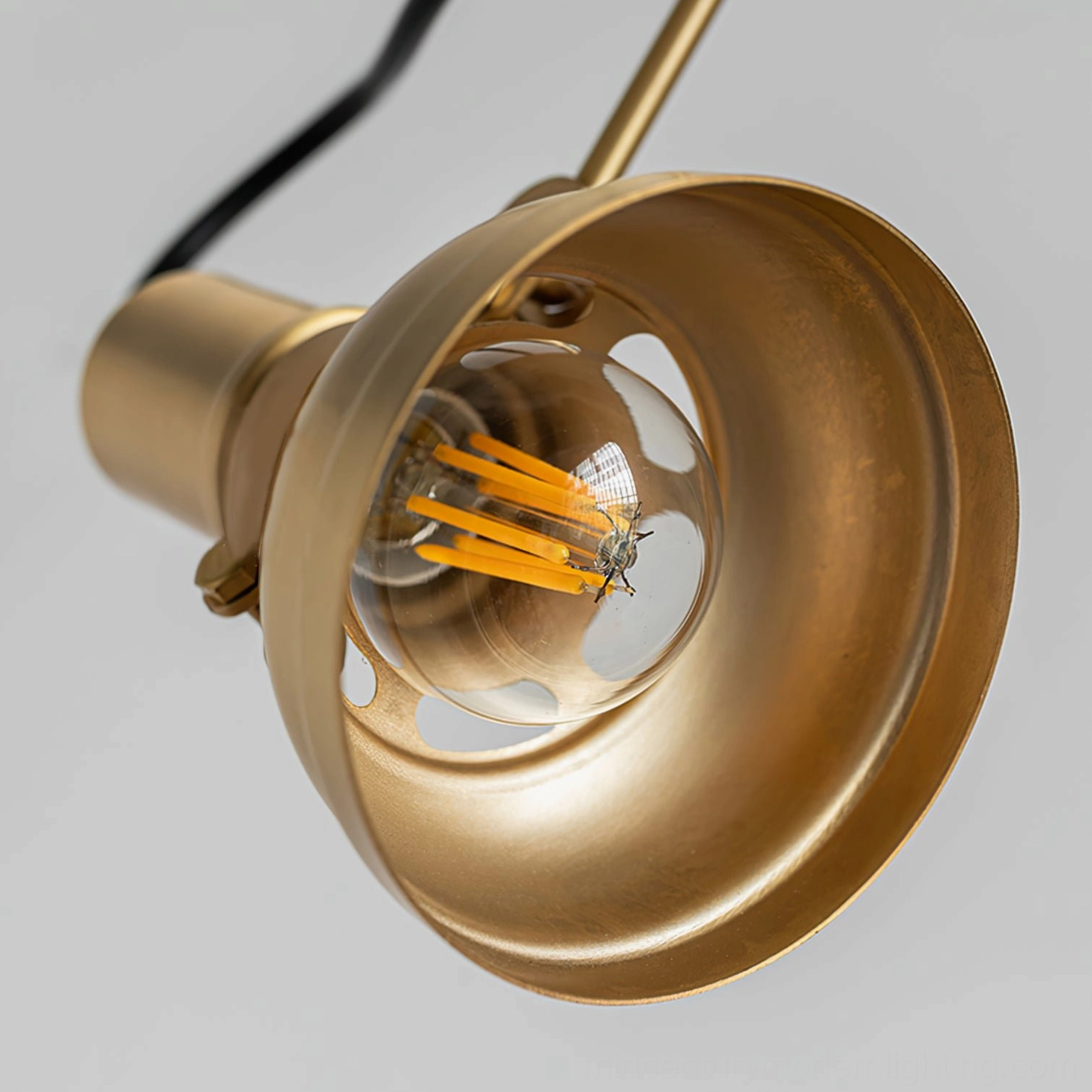 Kane swing arm lamp head showing ventilated brass shade with E26 E27 screw base socket and warm incandescent filament bulb