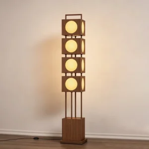 Kano Totem Floor Lamp illuminated in minimalist living room, warm light glowing through frosted acrylic shades, modern interior setting