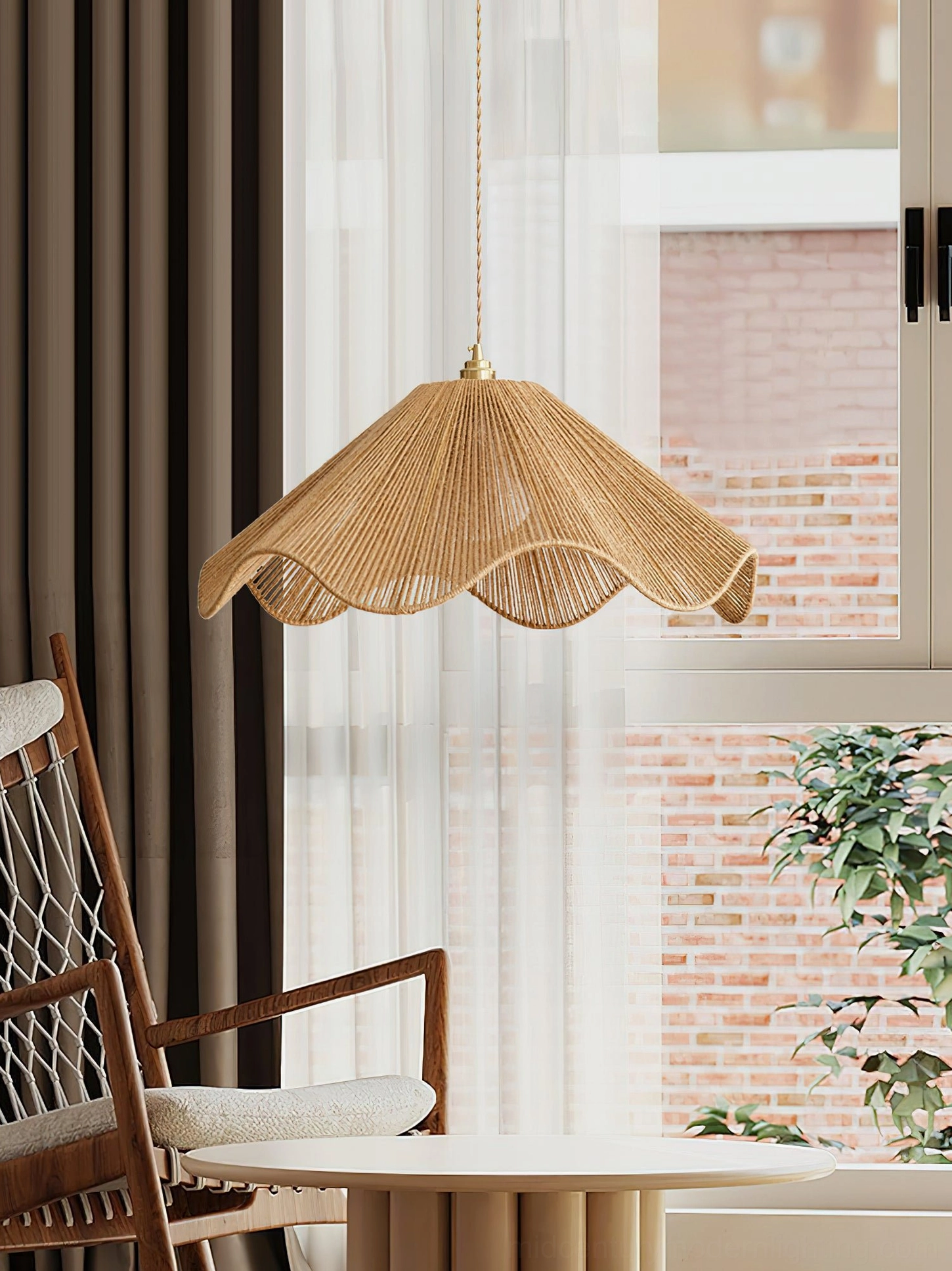 Karai boho pendant light with brass hanging fixtures mounted in residential seating area with natural window and wooden chair