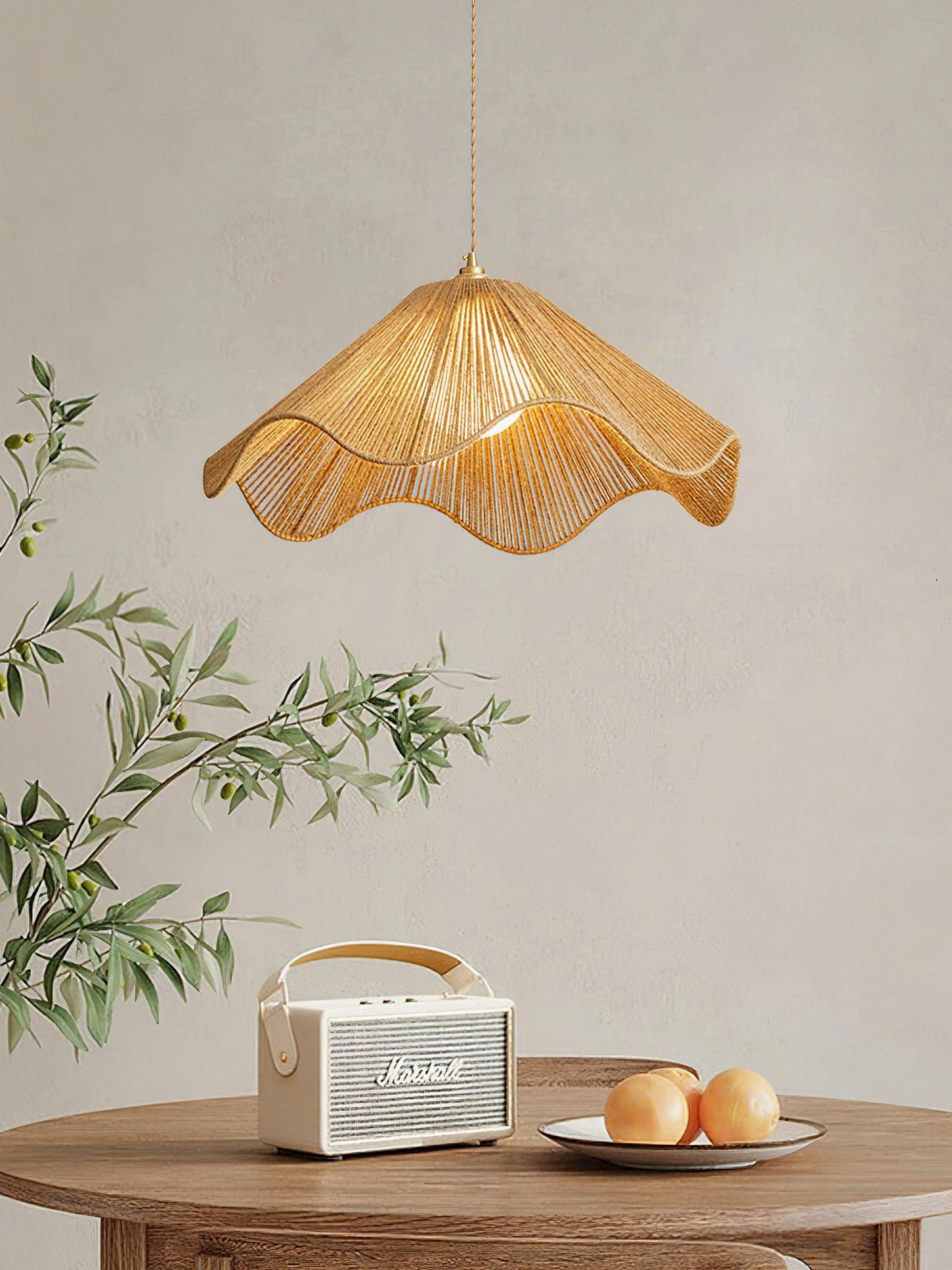Karai handwoven pendant lamp with soft warm lighting above dining table with retro radio and fresh fruit styling
