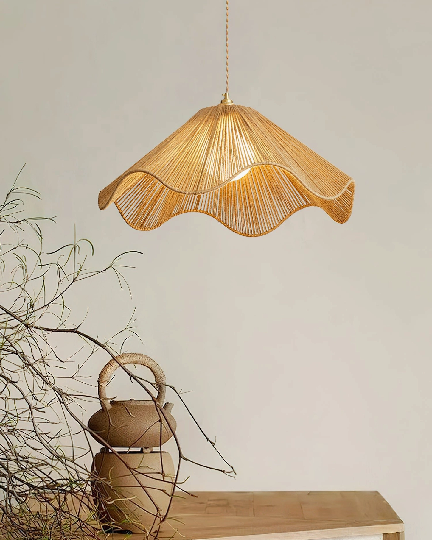 Illuminated Karai hemp rope pendant light casting warm glow over dining table with vintage teapot and retro decor