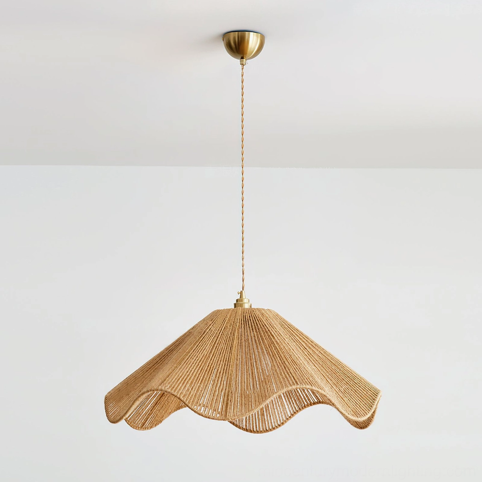 Karai coastal modern pendant lamp with natural rattan weave and twisted hanging cord, side angle perspective