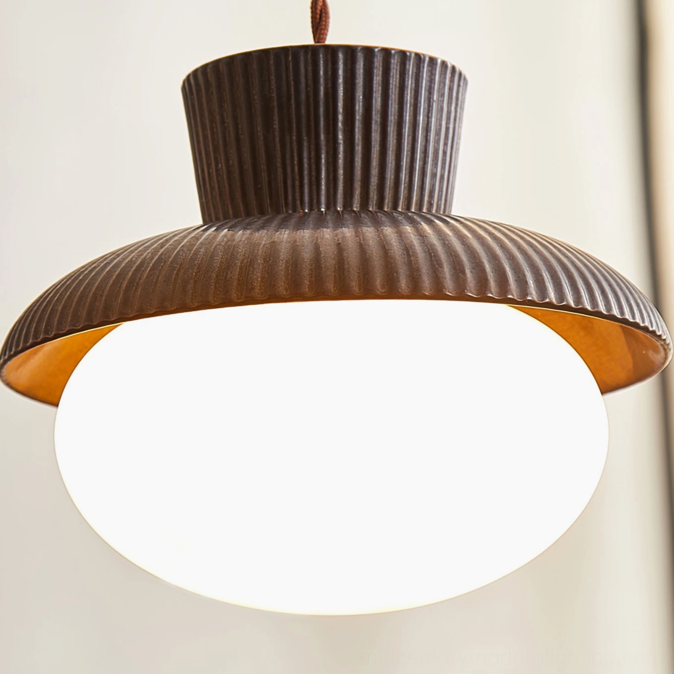 Kaskad pendant lamp unlit close-up angle showing gold-toned inner glass lining and frosted diffuser sphere design detail