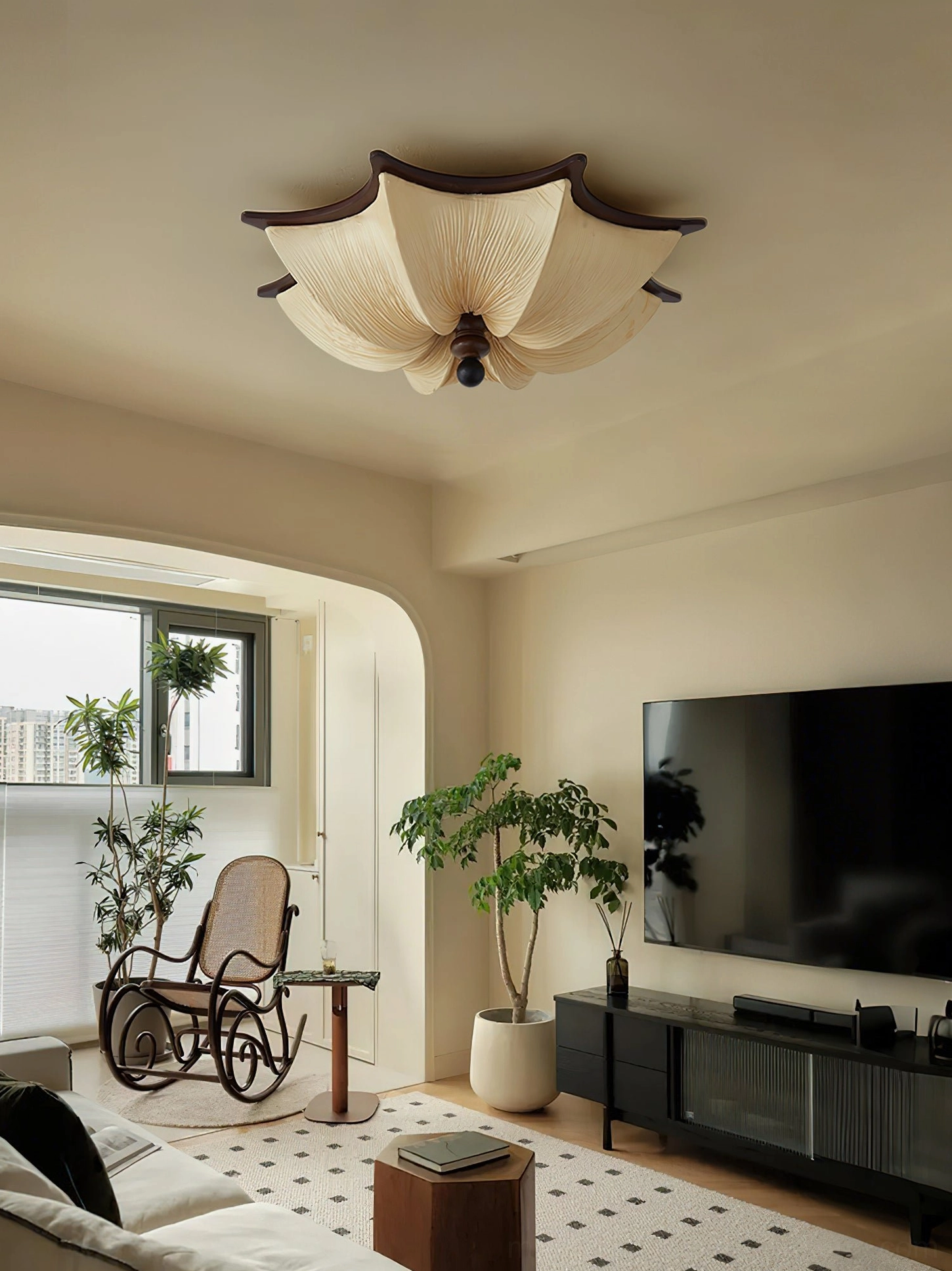 Warm-toned living space featuring Kateo ceiling mount light above media console with decorative plants