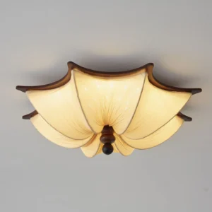 Close-up detail of Kateo ceiling lamp showing intricate hand-pleated textile shade construction and sculptured wood trim