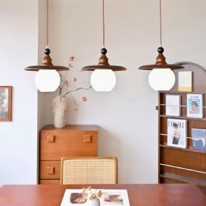 3-light Kato pendant fixture in vintage dining room with warm retro decor styling