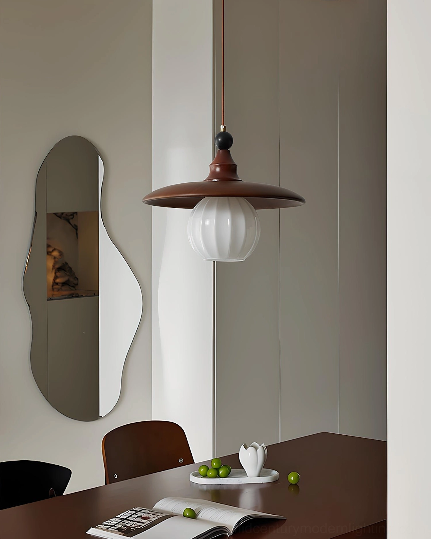 Single Kato pendant light wall-mounted in modern dining nook, retro aesthetic
