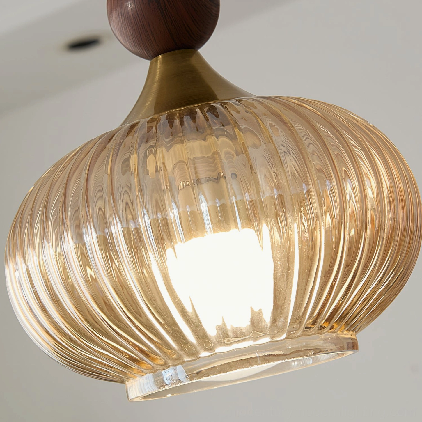 Kaydan ribbed glass pendant light positioned for ambient home illumination